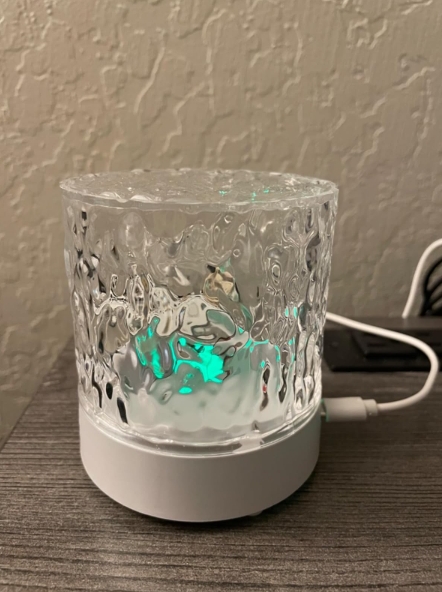 Upon receiving this item the first time around, I was very disappointed to see that there was no water/ripple effect. All it did was light up. Hoping that it was a defective item, I contacted seller and they immediately shipped me out a replacement. Kudos to the seller for outstanding customer service! So glad I waited to review this item because after receiving my replacement, I am in awe with this little lamp of awesomeness. It has a very soothing, tropical oasis vibe that I’m loving. There are many color selections to choose from; the primary being red, green, blue and white along with 12 more shades. There are also 4 different settings; flash, strobe, fade or smooth. I personally prefer the ripple effect with no setting. Comes with a little remote control and usb cord. The only thing I dislike is that when plugged in, it emits a green light that will not shut off (see pic). No biggie by any means, I just unplug it when not in use. Overall and based off my replacement, I highly recommend this product!